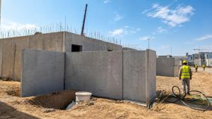 Precast boundary wall panels being erected at Al Arous villas development for Roshn